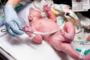 Newborn cute infant baby with umbilical cord